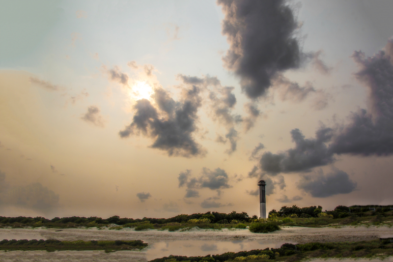 Lighthouse in front of a cloudy sky on Sullivan’s island beach South Carolina
